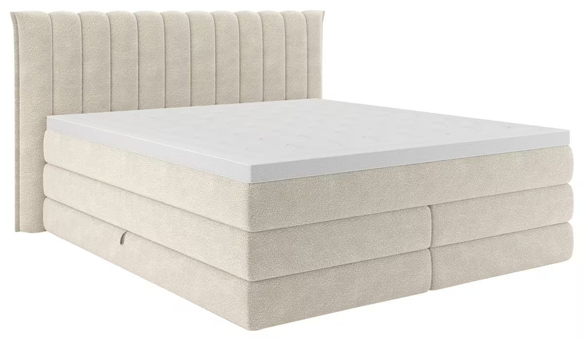 A contemporary upholstered bed featuring a multi-layered construction, typical of a continental or box spring system. It includes a substantial upholstered base, a primary mattress, and a visible mattress topper. The most distinctive feature is its integrated headboard, which is upholstered in a textured fabric and adorned with vertical channel tufting. The entire bed is presented in a light, neutral cream or off-white color, giving it a soft and modern aesthetic. — 3D model