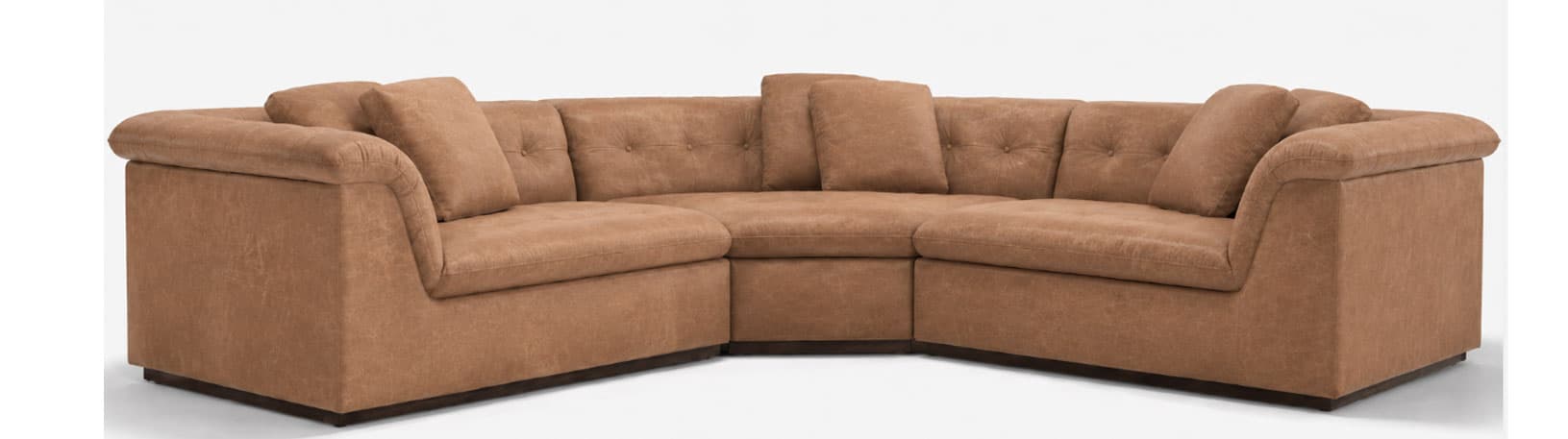 An L-shaped sectional sofa upholstered in a light brown, distressed faux-leather material. The sofa features plush, overstuffed seat and back cushions, with the back cushions exhibiting subtle button tufting. The arms are wide and gently rolled, contributing to a comfortable and inviting aesthetic. A dark, low-profile base underpins the entire structure. The modular design creates a spacious seating arrangement suitable for multiple occupants. — 3D model