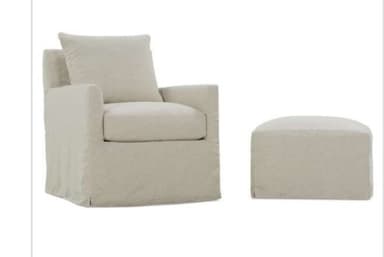 An upholstered armchair featuring a full, floor-length skirted base and a neutral-toned fabric. It has a loose back cushion and a removable seat cushion. — 3D model