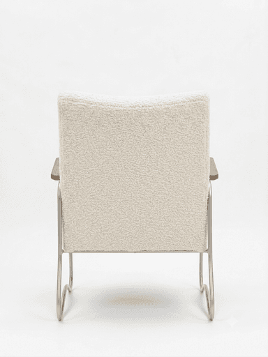 A contemporary armchair featuring an off-white bouclé upholstery on the seat and backrest, supported by a bent tubular metal frame. The armrests have wooden caps. The frame forms a continuous, sled-like base. — 3D model