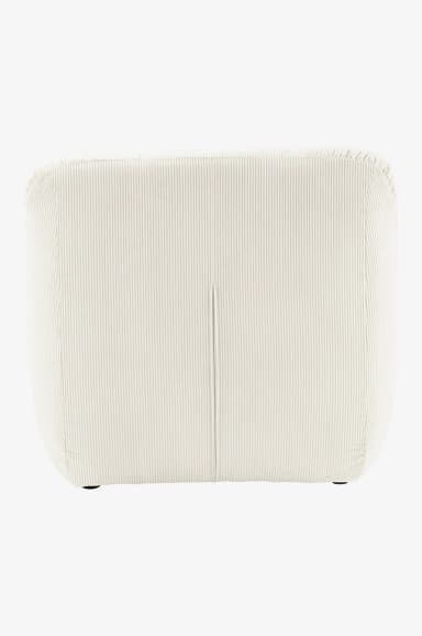 A low-profile armchair upholstered in cream-colored corduroy fabric. The armchair features a tufted backrest and seat, with plush, rounded armrests that seamlessly integrate into the base. The corduroy material exhibits distinct vertical ribbing, contributing to its textured appearance. The overall design is modular and contemporary, emphasizing comfort and a relaxed aesthetic. — 3D model