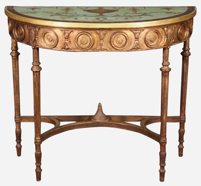 A semi-circular console table with ornate detailing. The table features a curved top with a decorative painted frieze depicting urns and floral motifs, bordered by a gold trim. The apron is adorned with a relief of circular medallions and decorative elements. The legs are slender and tapered, with reeded shafts and turned feet. A stretcher bar connects the legs near the base, featuring a central decorative finial. — 3D model
