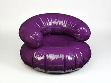 A white, inflatable armchair with a rounded base and a curved backrest that extends forward. The armchair features visible seams indicating its inflatable construction. It is placed on a red circular mat. — 3D model