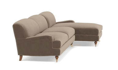 A modern sectional sofa with a chaise extension, upholstered in a light taupe fabric and featuring wooden legs, one with a brass caster. — 3D model