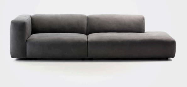 A two-piece contemporary modular sectional sofa upholstered in dark grey fabric. It features a low-profile design with clean, straight lines and an understated aesthetic. One module includes a backrest and a single armrest, while the adjoining module is armless, forming an L-shaped configuration suitable for various living spaces. The base appears recessed, giving the sofa a floating appearance. — 3D model