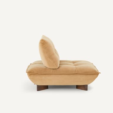 A low-profile, contemporary armless lounge chair featuring generous, plush tan upholstery and a rounded, pillowy form. It sits on small, recessed dark wood block feet. — 3D model