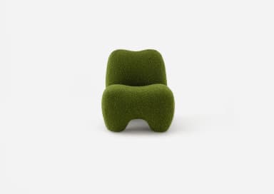 A low-slung, green, organic shaped lounge chair, entirely upholstered in a textured boucle fabric with a sculptural form, devoid of visible legs or distinct base. — 3D model