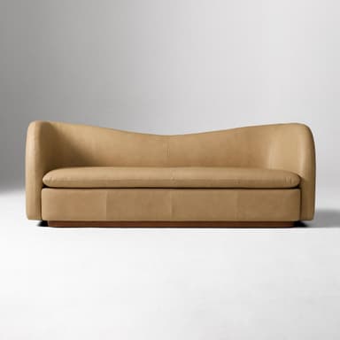 A contemporary two-seater loveseat upholstered in tan leather with a curved back and integrated armrests, resting on a dark wooden plinth base. — 3D model