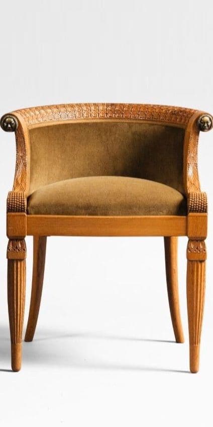 An antique armchair with a carved wooden frame and upholstered seat and back. The frame features fluted legs and ornate carvings along the top edge and arms. The upholstery is a textured, olive-green fabric. — 3D model