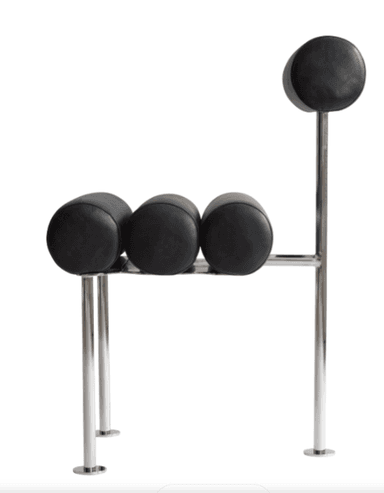 A postmodern chair featuring cylindrical bolster cushions for the seat and backrest, supported by a sleek, polished tubular metal frame. The upholstery is black, creating a striking contrast with the metallic frame. — 3D model