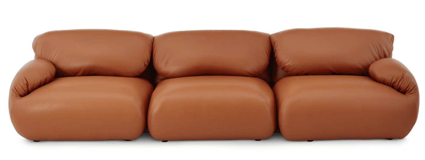 A three-seater sofa with rounded, modular-like segments. Each seat and backrest is a distinct plush cushion. The arms are low and merge seamlessly with the seat cushions. The upholstery has a smooth, matte finish, suggesting leather or a high-quality synthetic equivalent. — 3D model