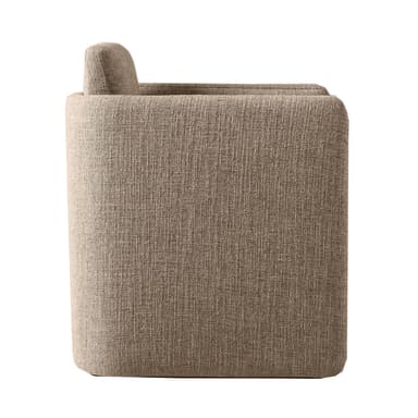 A contemporary armchair with a unique, geometric silhouette. The piece features a modular appearance with distinct, block-like sections forming the seat, backrest, and armrests. The upholstery is textured, suggesting a woven fabric. The overall form is solid and angular, yet the rounded edges of the visible surfaces provide a softer aesthetic. — 3D model