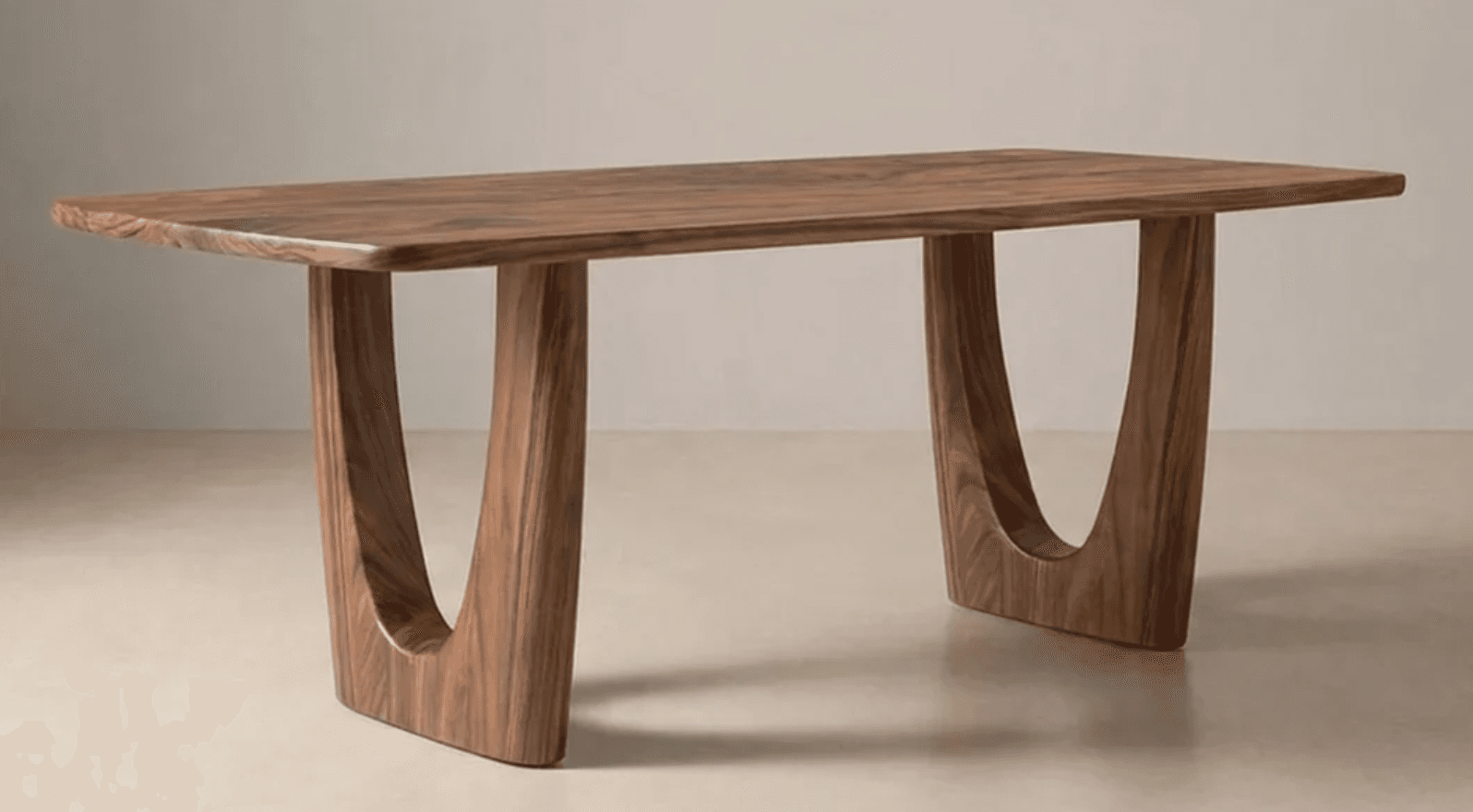 A rectangular dining table crafted from solid walnut wood, featuring a thick, smooth tabletop and two distinctive, curved slab legs. — 3D model