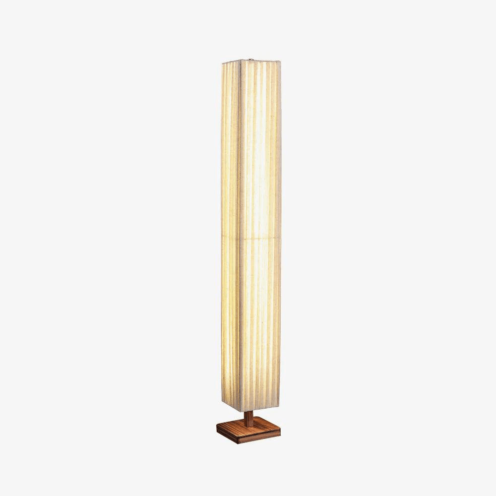 A tall, slender floor lamp featuring a rectangular column-shaped shade crafted from light-colored, vertically pleated fabric. The shade rests upon a square, flat base made of natural wood, providing stability. The lamp emits a soft, diffused light, characteristic of its minimalist design. — 3D model