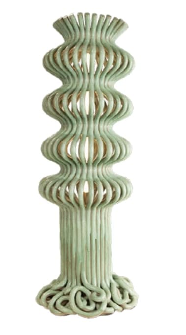 A tall, slender floor lamp crafted from rattan, featuring an undulating, wavy profile painted in a soft sage green. The lamp has an integrated light source visible through the open rattan structure, which is coiled at its base. — 3D model