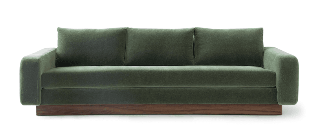 A modern three-seater sofa with green fabric upholstery and a prominent dark wood plinth base. It features clean lines, broad rounded armrests, and loose back cushions. — 3D model