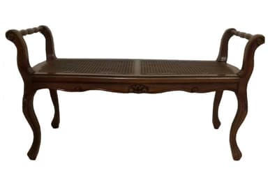 A classic French Provincial style bench featuring a dark stained wooden frame with intricate carvings and cabriole legs. The seat is constructed from two panels of woven cane, offering a breathable and textural surface. It includes gracefully curved armrests with carved details, enhancing its traditional aesthetic. The overall design suggests elegance and craftsmanship typical of 18th-century European furniture. — 3D model