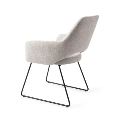 A contemporary armchair featuring a fully upholstered bucket-style seat and backrest in a light gray woven fabric. The chair is supported by a minimalist base of slender, black powder-coated metal legs, arranged in a distinctive inverted 'U' shape. — 3D model