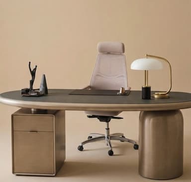 An elegant, modern executive desk featuring a distinct oval-shaped dark grey top contrasting with a champagne-gold finished body. The desk is supported by a solid cylindrical pedestal base on one side and an integrated three-drawer cabinet on the other, both matching the champagne-gold finish. The edges of the tabletop are smoothly rounded, complementing the overall contemporary design. — 3D model