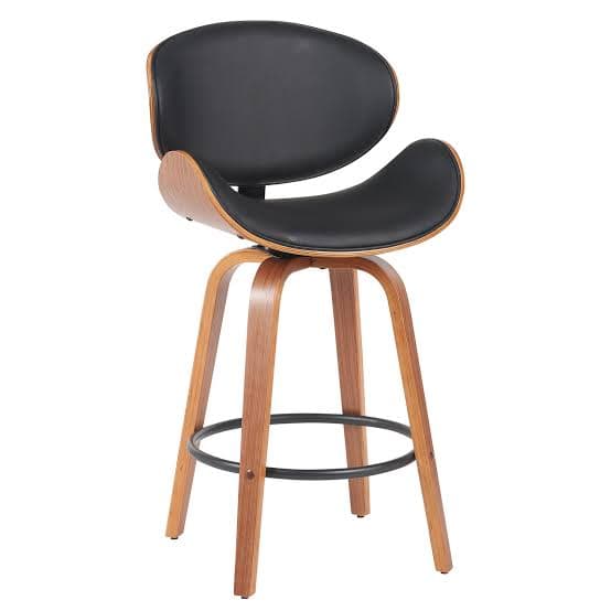 A modern bentwood bar stool featuring a contoured back and seat upholstered in black faux leather. The stool has a natural wood finish on its bent plywood frame, a 360-degree swivel mechanism, and a circular metal footrest integrated into its four-legged base. — 3D model