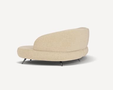 A modern curved sectional sofa, upholstered in a light beige or cream textured fabric, featuring a flowing, organic form and supported by slender, angled dark metal legs. — 3D model