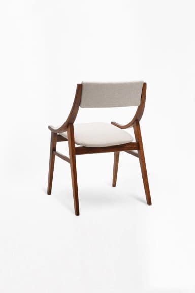 A modern armchair featuring a wooden frame and upholstered seat and backrest. The frame has a curved, organic design for the armrests and back supports, while the legs are straight and tapered. The upholstery is a neutral grey fabric. — 3D model