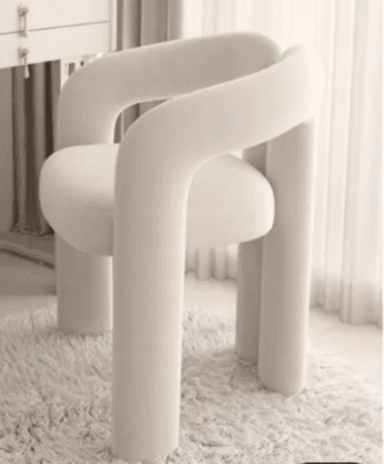 An off-white, fully upholstered accent chair featuring a distinctive sculptural and tubular design. The chair is entirely covered in a textured bouclé fabric, with thick, rounded forms defining the seat, backrest, armrests, and legs. The design is contemporary, emphasizing soft, organic curves and a monolithic appearance. — 3D model