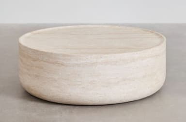 A round, low-profile coffee table constructed entirely from light-colored travertine, featuring a solid cylindrical base and a flat top surface with a subtle raised edge or lip. The natural banding of the stone is visible across the entire piece, giving it an earthy and minimalist aesthetic. — 3D model