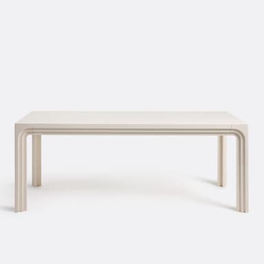 A close-up view of a table's surface and leg. The surface appears to be a high-gloss, off-white material, reflecting light. The leg has a distinctive carved design with layered, curved elements, reminiscent of a waterfall or architectural molding. The overall construction suggests a modern or contemporary style. — 3D model