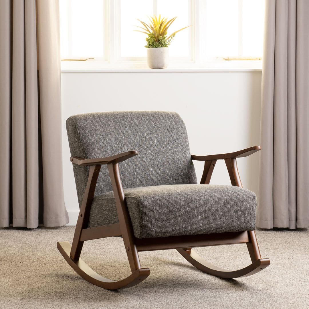 A wooden rocking chair with upholstered seating and backrest. The chair features curved wooden armrests and a frame constructed from dark wood. The rocking mechanism is integrated into the base with curved runners. — 3D model