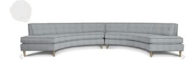 A light grey, two-piece curved sectional sofa featuring a low profile, button-tufted backrests, and light-colored, tapered wooden legs. The design is modern and consists of two sections that form a gentle arc. — 3D model