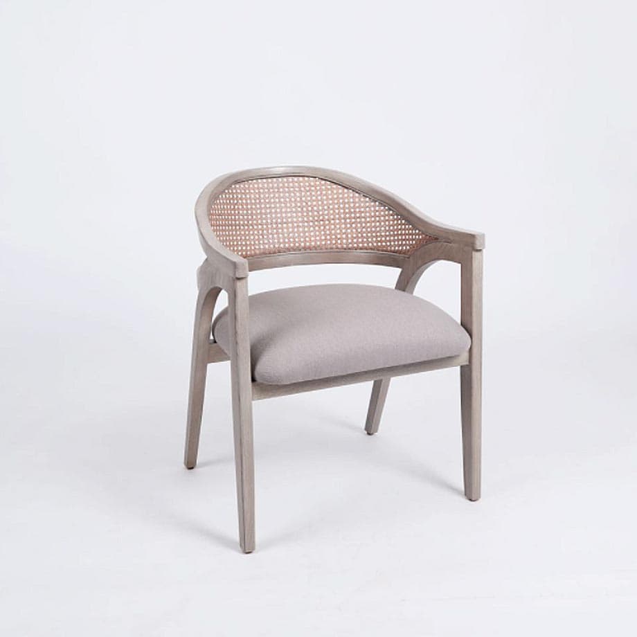 A transitional armchair featuring a light-toned wooden frame with a curved silhouette, integrated armrests, a natural woven cane backrest, and an upholstered light grey fabric seat cushion. — 3D model