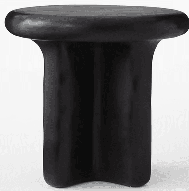 A modern side table with a rounded, irregular top and a sculpted base. The base appears to be formed from three distinct, fluid-like columns that merge towards the top. — 3D model
