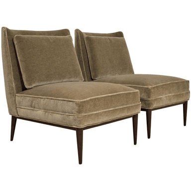 An armless upholstered slipper chair featuring a deep seat, a separate back cushion, and four tapered wooden legs. The chair is covered in a soft, olive green velvet or velour fabric, suggesting a comfortable and stylish seating option. — 3D model