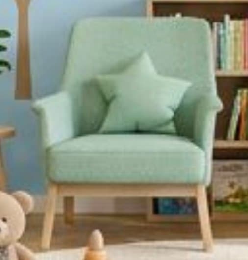 A contemporary armchair upholstered in a mint green fabric, featuring a rounded backrest, integrated armrests, and splayed natural wood legs. A matching star-shaped throw pillow is included. — 3D model