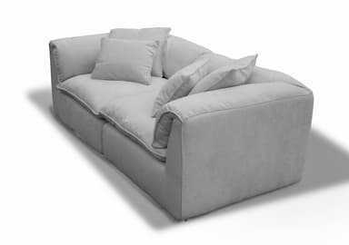 A contemporary deep-seated sofa, upholstered in a light gray textured fabric, featuring plush, loose seat and back cushions for maximum comfort. The design includes additional throw pillows and boasts a clean, monolithic silhouette with fully upholstered arms and base. — 3D model