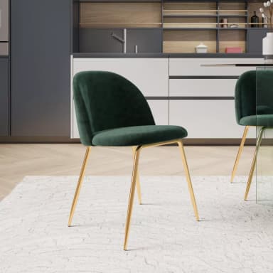 An armless dining chair featuring a curved back and seat upholstered in emerald green velvet, supported by four slender, gold-finished metal legs. — 3D model