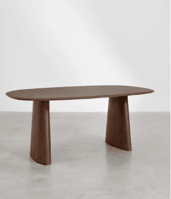 A modern dining table with an oval, elongated tabletop and two solid, curved pedestal legs. The legs are wider at the base and taper upwards to connect to the underside of the tabletop. The surface of the tabletop appears to be smooth with a visible wood grain pattern. — 3D model