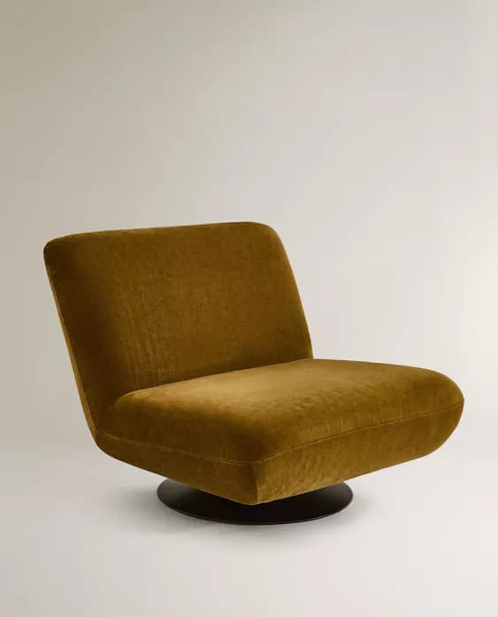 An armless, low-profile lounge chair upholstered in olive green fabric, featuring a broad seat and backrest, supported by a circular black metal swivel base. — 3D model