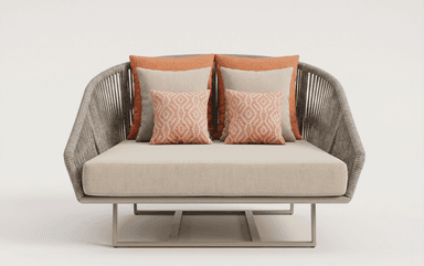 A contemporary daybed constructed with a woven rope frame and a metal base. It features a plush, light-colored cushion and several decorative pillows in coral and beige tones. The design suggests suitability for outdoor or modern indoor use. — 3D model
