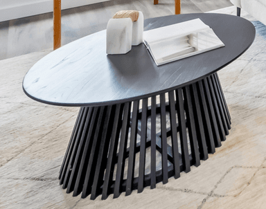 A modern black oval coffee table featuring a sculptural base composed of numerous vertically oriented slats forming a tapered, conical shape, supporting a smooth oval tabletop. — 3D model