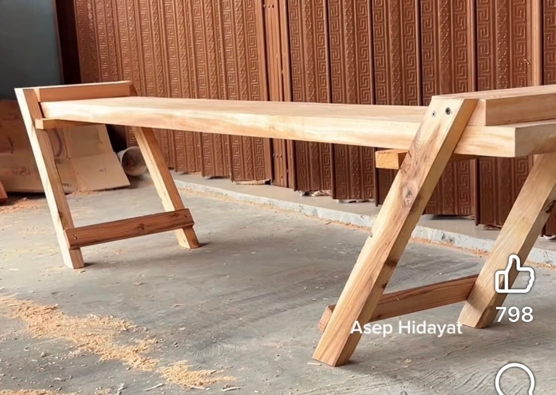 A minimalist slatted wooden bench with angled A-frame style legs, featuring light natural wood and visible, straightforward joinery. — 3D model