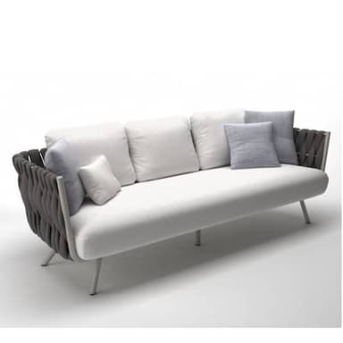 A modern three-seater sofa featuring a clean, minimalist design. It has a generously cushioned base and three loose back cushions upholstered in a light grey or white fabric. The distinctive armrests and a partial backrest are crafted from dark grey woven rope or synthetic cord, providing a textural contrast. The sofa is supported by slender, splayed metal legs with a light finish. — 3D model