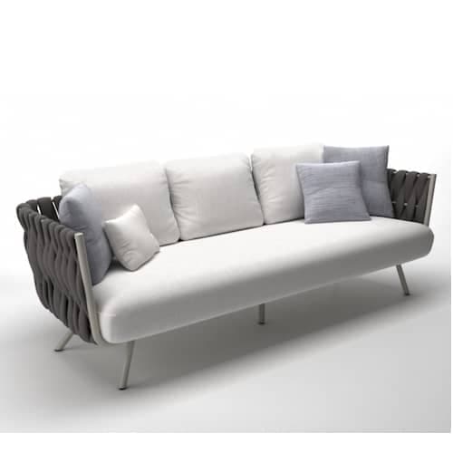 A modern three-seater sofa featuring a clean, minimalist design. It has a generously cushioned base and three loose back cushions upholstered in a light grey or white fabric. The distinctive armrests and a partial backrest are crafted from dark grey woven rope or synthetic cord, providing a textural contrast. The sofa is supported by slender, splayed metal legs with a light finish. — 3D model