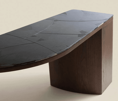 A dark wood corner desk with a marble-patterned top. The desk has a distinctive angular shape, with one side featuring a closed cabinet or drawer unit. The legs are thick and rectangular, with rounded edges. The top surface has a marbling pattern with grey and white tones on a dark base. — 3D model