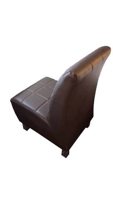 An armless chair upholstered in dark brown faux leather, featuring a distinctive square tufting pattern across both the seat and the tall, slightly curved backrest. The chair has a minimalist profile with short, concealed legs, presenting a contemporary or transitional aesthetic. — 3D model