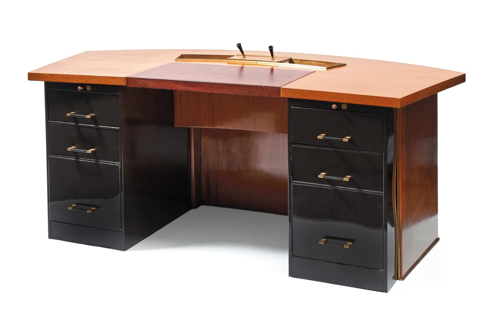 A large, executive-style desk with a curved front. The desk features a light-colored wood top, a central section with a darker wood finish, and two pedestal bases containing drawers. The drawer fronts and casings of the pedestals are a high-gloss dark color, possibly black or deep brown, accented with brass hardware. The rear of the desk appears to be constructed of wood panels. A recessed area in the central top section contains two brass elements, possibly pen holders or accessories. — 3D model