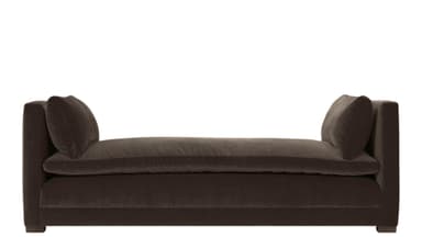 A low-profile upholstered daybed with a rectangular seat cushion and two scatter cushions placed against the high, padded armrests. The daybed features a continuous upholstered base and appears to be covered in a soft velvet fabric. — 3D model