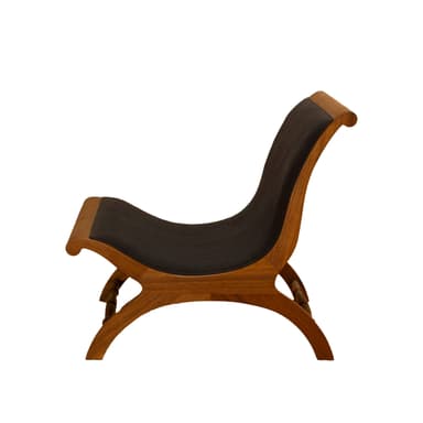 A low-profile X-frame lounge chair constructed from richly toned wood and upholstered in dark material. The frame features curved, intersecting legs that form an 'X' shape, connected by a turned stretcher bar at the back. The seat and backrest are simple, suspended panels of dark upholstery, providing a comfortable recline. The wooden frame has smooth, rounded edges, indicative of quality craftsmanship. — 3D model