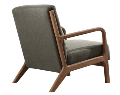 A modern armchair with a wooden frame and upholstered seat and backrest. The frame has a natural wood finish and features curved armrests and angled legs. A small, matching upholstered pillow is placed against the backrest for added comfort. The upholstery appears to be a textured fabric. — 3D model